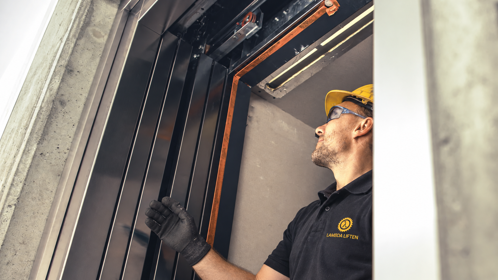 Monteur van Lambda Liften inspecteert een liftinstallatie